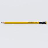 A sharpened yellow Blackwing x Fender pencil with a black ferrule and yellow eraser, shown horizontally against a light background.