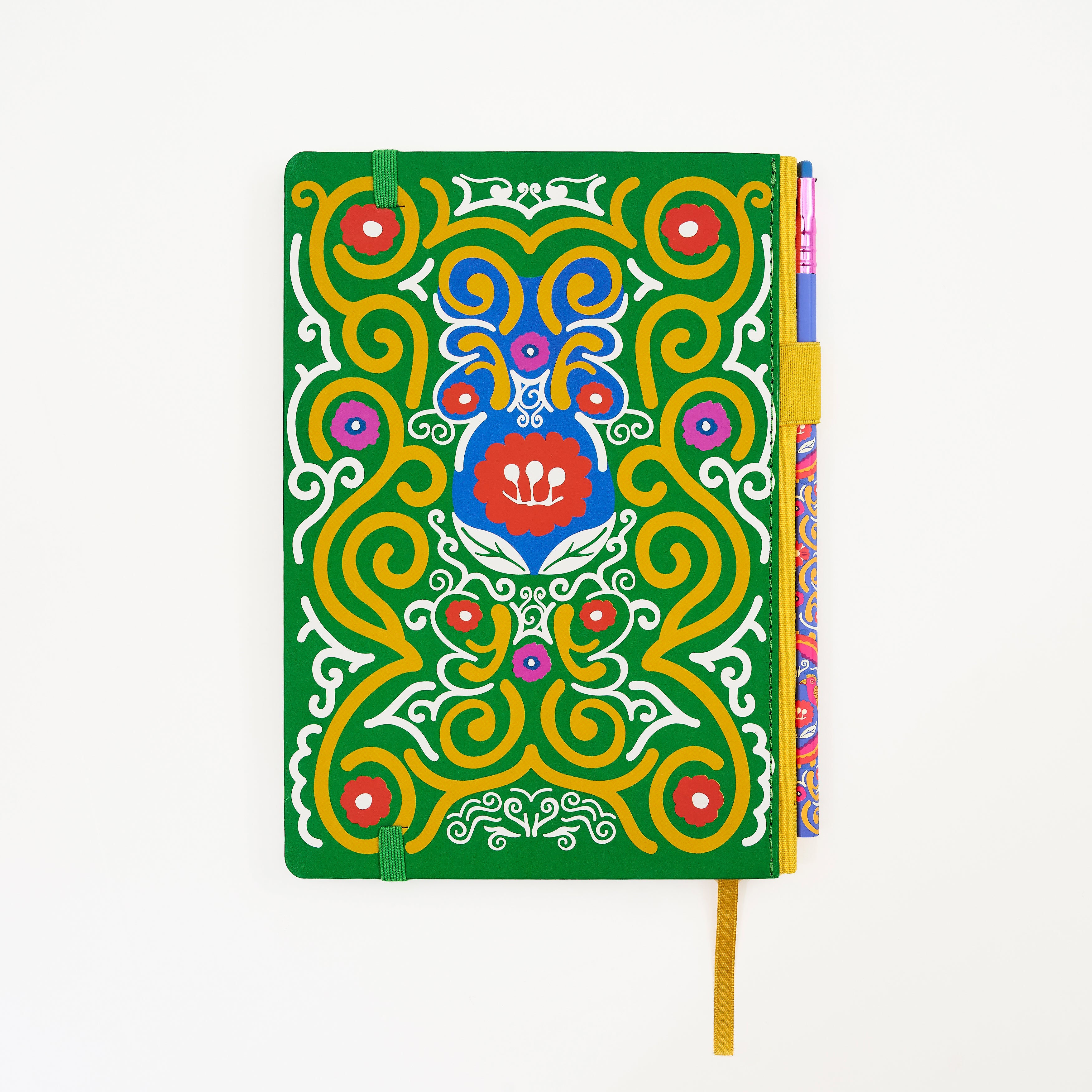 Back of a hardcover notebook with a vibrant green cover decorated with a colorful, symmetrical mandala-style illustration. The notebook features a matching pencil in the side pencil holster, set against a plain white background.