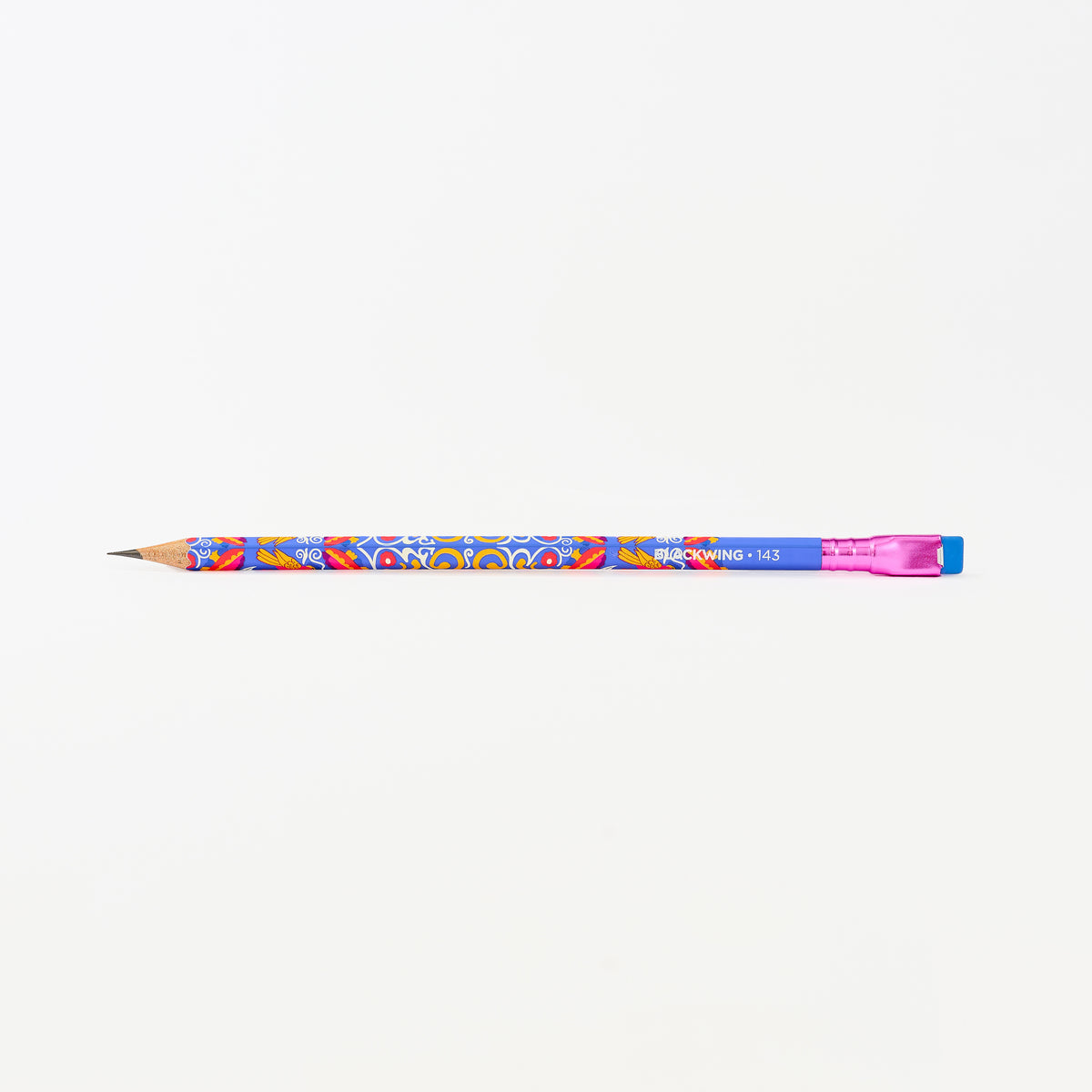A colorful wooden pencil with a blue body, vibrant multicolor floral pattern, a pink ferrule, and a blue eraser shown horizontally against a plain white background.
