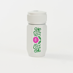 A white Blackwing one-step sharpener  featuring a green vine pattern and a pink flower graphic on the side.