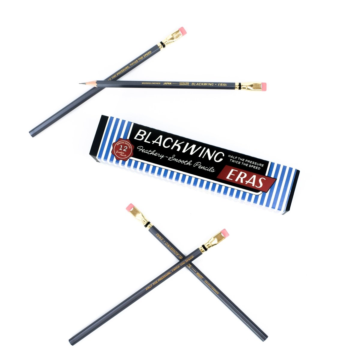 Twelve Blackwing drawing and sketching pencils with grey barrels, pink erasers, shown with their blue and white striped packaging box on a clean white background.