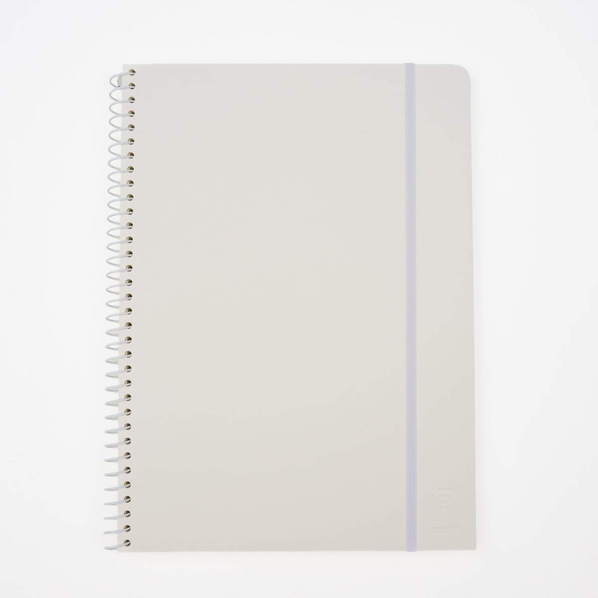 A large minimalist spiral-bound notebook by Blackwing with a white cover, a thin white elastic band, and a white wire coil binding, shown on a clean white background. It features a 'B' Blackwing emblem in the bottom-right corner.