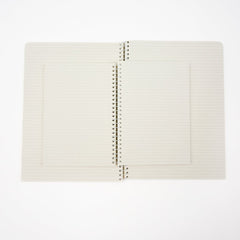 A stack of two open lined spiral notebooks with cream-colored pages and white metal wire binding, set against a plain white background.