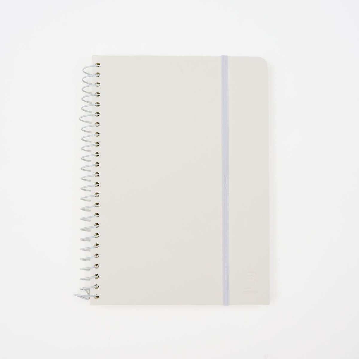 A minimalist spiral-bound notebook by Blackwing with a white cover, a thin white elastic band, and a white wire coil binding, shown on a clean white background. It features a 'B' Blackwing emblem in the bottom-right corner.