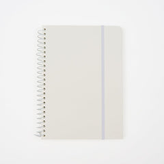 A minimalist spiral-bound notebook by Blackwing with a white cover, a thin white elastic band, and a white wire coil binding, shown on a clean white background. It features a 'B' Blackwing emblem in the bottom-right corner.