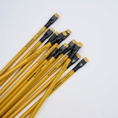 A set of yellow wood pencils with black ferrules and yellow erasers, arranged diagonally on a clean white background. The pencil barrels feature black text reading 'BLACKWING x Fender' and 'TELECASTER'.