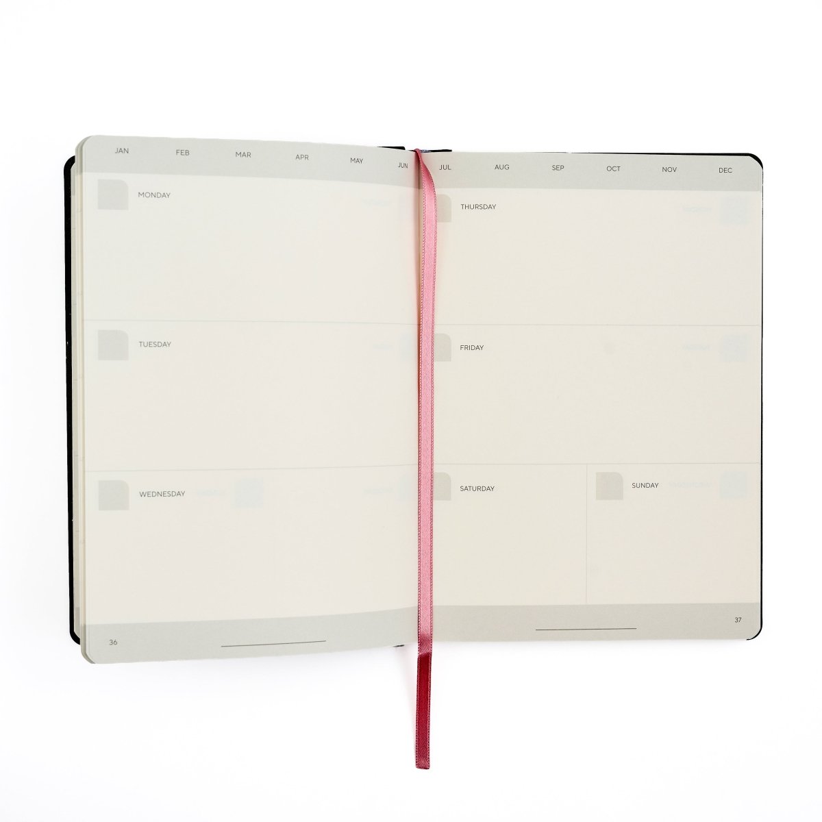 An open weekly Blackwing planner with blank day slots on the inside pages, held open by a pink ribbon bookmark, shown on a white background.