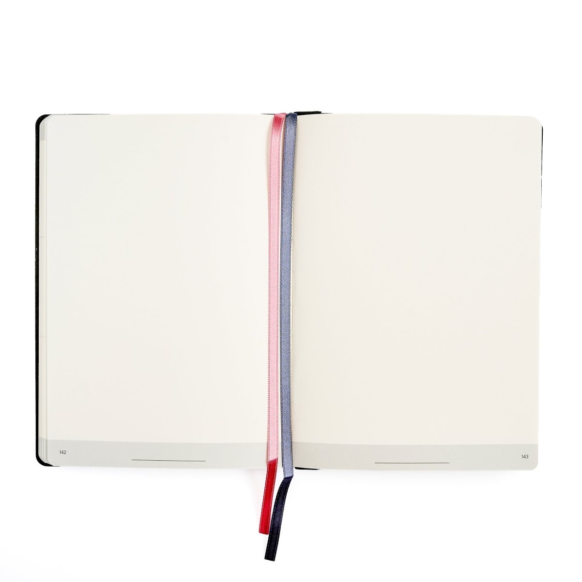 An open Blackwing planner with blank cream-colored pages, held open by one pink and one grey ribbon bookmarks with, on a solid white background.