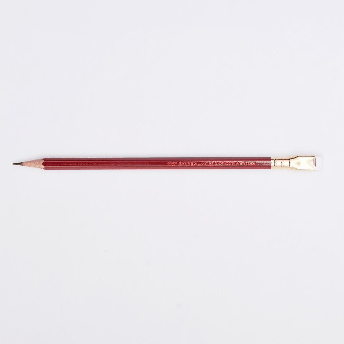red pencil with imprint 'THE BETTER ANGELS OF OUR NATURE' on a white background