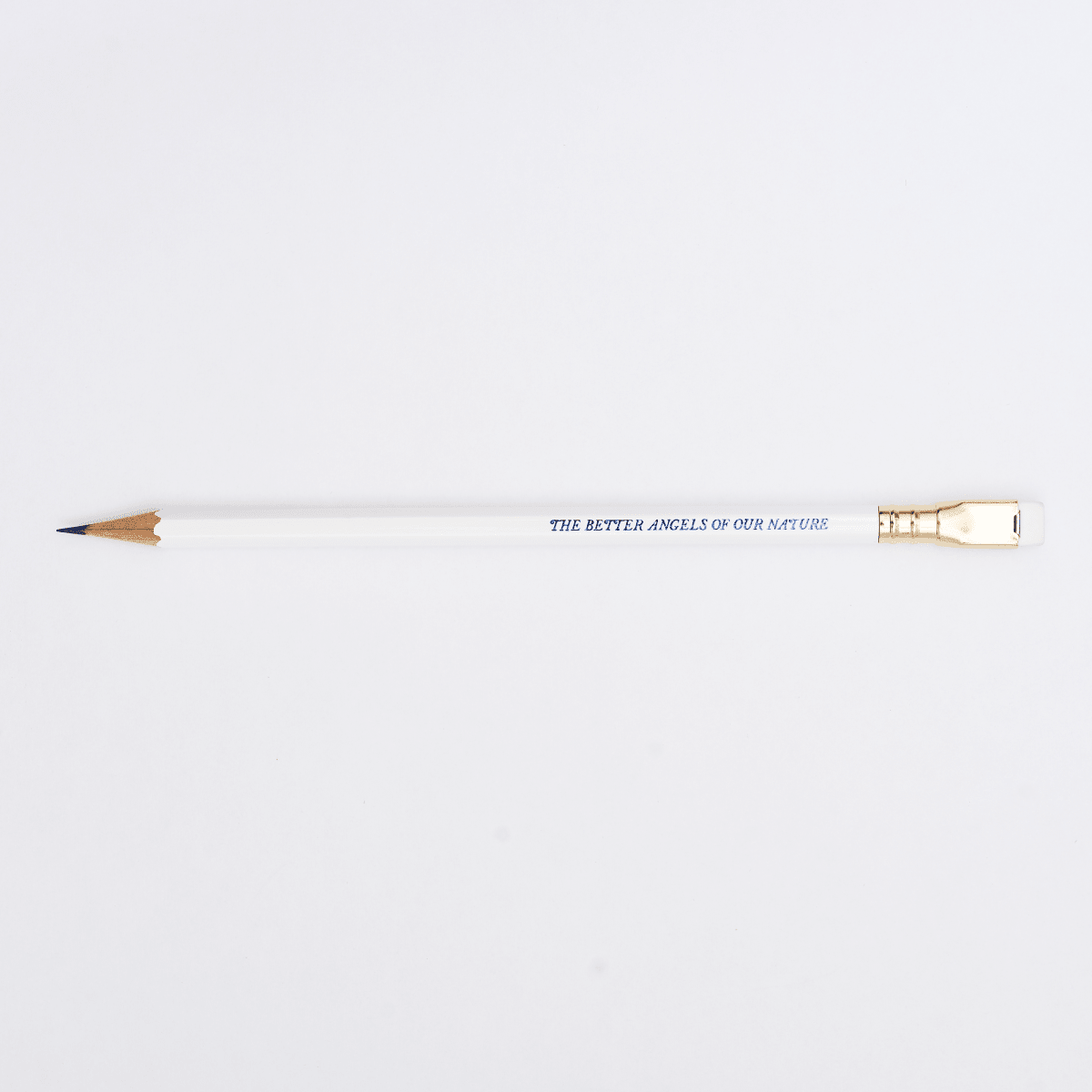white pencil sharpened on a white background with pencil barrel text in blue that says 'THE BETTER ANGELS OF OUR NATURE'.