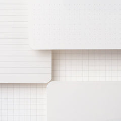 Blackwing Slate Notebooks displaying paper types: dot-grid, ruled, grid, and blank
